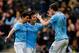 HULL, ENGLAND - MARCH 15: Edin Dzeko (R) of Manchester City celebrates his goal with team mates Jesus Navas (L) and David Silva during the Barclays Premier League match between Hull City and Manchester City at the KC Stadium on March 15, 2014 in Hull, Eng