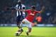 WEST BROMWICH, ENGLAND - MARCH 08: Shinji Kagawa of Manchester United tackles Youssuf Mulumbu of West Bromwich Albion during the Barclays Premier League match between West Bromwich Albion and Manchester United at The Hawthorns on March 8, 2014 in West Br