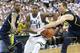 EAST LANSING, MI - JANUARY 25: Keith Appling #11 of the Michigan State Spartans drives the ball to the basket as Glenn Robinson III #1 and Nik Stauskas #11 of the University of Michigan defend during the second half of the game at Breslin Center on Januar