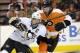 Mar 15, 2014; Philadelphia, PA, USA; Pittsburgh Penguins center Sidney Crosby (87) tries to skate around Philadelphia Flyers center Sean Couturier (14) during the first period at Wells Fargo Center. Mandatory Credit: Eric Hartline-USA TODAY Sports
