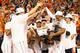 GREENSBORO, NC - MARCH 16: Teammates gather around Joe Harris #12 of the Virginia Cavaliers after he won the MVP against the Duke Blue Devils during the championship game of the 2014 Men's ACC Basketball Tournament at Greensboro Coliseum on March 16, 201