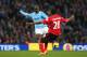MANCHESTER, ENGLAND - JANUARY 18: Yaya Toure of Manchester City shoost past Kevin Theophile Catherine of Cardiff to score his team's third goal during the Barclays Premier League match between Manchester City and Cardiff City at the Etihad Stadium on Jan