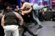 Luke Harper dives out of the ring onto Dean Ambrose.