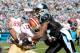 CHARLOTTE, NC - JANUARY 12: Michael Crabtree #15 of the San Francisco 49ers is tackled by Captain Munnerlyn #41 of the Carolina Panthers in the first quarter during the NFC Divisional Playoff Game at Bank of America Stadium on January 12, 2014 in Charlott