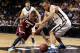 NEW YORK, NY - MARCH 14: Chaz Williams #3 of the Massachusetts Minutemen and Kevin Larsen #21 of the George Washington Colonials go for a loose ball in the second half during the Quarterfinals of the 2014 Atlantic 10 Men's Basketball Tournament at Barclay