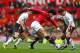 MANCHESTER, ENGLAND - MARCH 16: Marouane Fellaini of Manchester United competes with Joe Allen (R) and Steven Gerrard of Liverpool during the Barclays Premier League match between Manchester United and Liverpool at Old Trafford on March 16, 2014 in Manch
