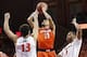 Mar 1, 2014; Charlottesville, VA, USA; Syracuse Orange guard Tyler Ennis (11) shoots the ball in front of Virginia Cavaliers forward Anthony Gill (13) and Cavaliers guard Justin Anderson (1) in the first half at John Paul Jones Arena. Mandatory Credit: Ge