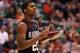 SALT LAKE CITY, UT - MARCH 23: Wesley Saunders #23 of the Harvard Crimson holds onto his shoe in the first half while taking on the Arizona Wildcats during the third round of the 2013 NCAA Men's Basketball Tournament at EnergySolutions Arena on March 23,