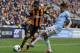 HULL, ENGLAND - MARCH 15: Ahmed Elmohamady (L) of Hull City is tackled by Gael Clichy of Manchester City during the Barclays Premier League match between Hull City and Manchester City at the KC Stadium on March 15, 2014 in Hull, England. (Photo by Clint