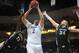 Mar 15, 2014; Las Vegas, NV, USA; New Mexico State Aggies player Sim Bhullar (2) protects the ball from defending Idaho Vandals players Bira Seck (13) and Stephen Madison (34) in the championship game for the WAC Conference college basketball tournament a