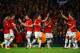 MANCHESTER, ENGLAND - MARCH 19: Robin van Persie of Manchester United celebrates scoring the second goal with his team-mates during the UEFA Champions League Round of 16 second round match between Manchester United and Olympiacos FC at Old Trafford on Ma
