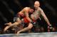 GOLD COAST, AUSTRALIA - DECEMBER 15: Norman Parke (L) lifts Colin Fletcher during the Lightwieght final bout between Colin Fletcher and Norman Parke at Gold Coast Convention and Exhibition Centre on December 15, 2012 on the Gold Coast, Australia. (Photo