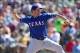 Mar 15, 2014; Phoenix, AZ, USA; Texas Rangers starting pitcher Colby Lewis (48) pitches in the first inning against the Oakland Athletics at Phoenix Municipal Stadium. Mandatory Credit: Joe Camporeale-USA TODAY Sports