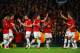 MANCHESTER, ENGLAND - MARCH 19: Robin van Persie of Manchester United celebrates scoring the second goal with his team-mates during the UEFA Champions League Round of 16 second round match between Manchester United and Olympiacos FC at Old Trafford on Ma