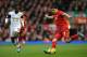 LIVERPOOL, ENGLAND - FEBRUARY 23: Luis Suarez of Liverpool competes with Nathan Dyer of Swansea City during the Barclays Premier League match between Liverpool and Swansea City at Anfield on February 23, 2014 in Liverpool, England. (Photo by Clive Bruns