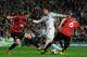 MADRID, SPAIN - FEBRUARY 13: Cristiano Ronaldo of Real Madrid is put under pressure by Jonny Evans and Phil Jones of Manchester United during the UEFA Champions League Round of 16 first leg match between Real Madrid and Manchester United at Estadio Sant