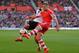 SOUTHAMPTON, ENGLAND - MARCH 15: Luke Shaw of Southampton clears the ball away from Johan Elmander of Norwich during the Barclays Premier League match between Southampton and Norwich City at St Mary's Stadium on March 15, 2014 in Southampton, England. (
