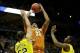Mar 22, 2014; Milwaukee, WI, USA; Texas Longhorns center Cameron Ridley (55) shoots a jump shot over Michigan Wolverines forward Jordan Morgan (52) and guard Caris LeVert (23) in the second half of a men's college basketball game during the third round of