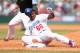SYDNEY, AUSTRALIA - MARCH 23: Yasiel Puig of the Dodgers is tagged out sliding back to first base during the MLB match between the Los Angeles Dodgers and the Arizona Diamondbacks at Sydney Cricket Ground on March 23, 2014 in Sydney, Australia. (Photo b
