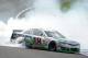 FONTANA, CA - MARCH 23: Kyle Busch, driver of the #18 Interstate Batteries Toyota, celebrates with a burnout after winning the NASCAR Sprint Cup Series Auto Club 400 at Auto Club Speedway on March 23, 2014 in Fontana, California. (Photo by Harry How/Get