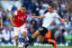 LONDON, ENGLAND - MARCH 16: Alex Oxlade-Chamberlain of Arsenal evades the tackle of Nabil Bentaleb of Tottenham Hotspur during the Barclays Premier League match between Tottenham Hotspur and Arsenal at White Hart Lane on March 16, 2014 in London, England