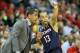 Mar 15, 2014; Memphis, TN, USA; Connecticut Huskies head coach Kevin Ollie talks to guard Shabazz Napier (13) during the first half against the Louisville Cardinals in final of the American Athletic Conference college basketball tournament at FedEx Forum.