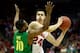 MILWAUKEE, WI - MARCH 22: Bronson Koenig #24 of the Wisconsin Badgers looks to pass the ball against Johnathan Loyd #10 of the Oregon Ducks during the third round of the 2014 NCAA Men's Basketball Tournament at BMO Harris Bradley Center on March 22, 2014