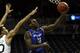 NEW YORK, NY - DECEMBER 21: Javon McCrea #12 of the Buffalo Bulls drives to the basket past Ashton Pankey #30 of the Manhattan Jaspers during the Brooklyn Hoops Holiday Invitational at Barclays Center on December 21, 2013 in the Brooklyn borough of New Y