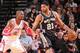 HOUSTON, TX - JANUARY 28: Tim Duncan #21 of the San Antonio Spurs handles the ball against Dwight Howard #12 of the Houston Rockets on January 28, 2014 at the Toyota Center in Houston, Texas. NOTE TO USER: User expressly acknowledges and agrees that, by