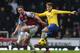 LONDON, ENGLAND - DECEMBER 26: Aaron Ramsey of Arsenal holds off Kevin Nolan of West Ham United during the Barclays Premier League match between West Ham United and Arsenal at Boleyn Ground on December 26, 2013 in London, England. (Photo by Ian Walton/G