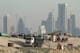 DOHA, QATAR - OCTOBER 26: Trucks stand at a construction site across from skyscrapers in the budding new financial district on October 26, 2011 in Doha, Qatar. Qatar, which is undergoing rapid urban development, will host the 2022 FIFA World Cup football