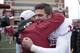 Bell (right) hugs coach Bob Stoops.