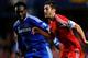LONDON, ENGLAND - DECEMBER 01: Adam Lallana of Southampton is chased by Michael Essien of Chelsea during the Barclays Premier League match between Chelsea and Southampton at Stamford Bridge on December 1, 2013 in London, England. (Photo by Mike Hewitt/G