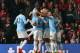 MANCHESTER, ENGLAND - MARCH 25: Edin Dzeko of Manchester City celebrates with his team-mates after scoring the opening goal during the Barclays Premier League match between Manchester United and Manchester City at Old Trafford on March 25, 2014 in Manche