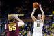 Mar 1, 2014; Ann Arbor, MI, USA; Michigan Wolverines guard Nik Stauskas (11) shoots the ball over Minnesota Golden Gophers center Elliott Eliason (55) in the first half at Crisler Arena. Mandatory Credit: Rick Osentoski-USA TODAY Sports