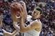 Mar 23, 2014; San Diego, CA, USA; Arizona Wildcats forward Aaron Gordon (right) pulls down a rebound against Gonzaga Bulldogs guard/forward Drew Barham (43) and guard David Stockton in the first half of a men's college basketball game during the third rou