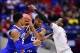 Mar 28, 2014; Indianapolis, IN, USA; Kentucky Wildcats guard Andrew Harrison (5) watches as guard Aaron Harrison (middle) is defended by Louisville Cardinals guard Russ Smith (right) in the second half in the semifinals of the midwest regional of the 2014
