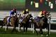DUBAI, UNITED ARAB EMIRATES - JANUARY 09: Christophe Soumillon riding Anaerobio (R)wins Race 7, Longines Conquest Classic during the first Longines Carnival Meeting at the Meydan Racecourse on January 9, 2014 in Dubai, United Arab Emirates. (Photo by Fr