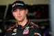 DAYTONA BEACH, FL - FEBRUARY 21: Denny Hamlin, driver of the #11 FedEx Express Toyota, stands in the garage area during practice for the NASCAR Sprint Cup Series Daytona 500 at Daytona International Speedway on February 21, 2014 in Daytona Beach, Florida