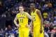 Mar 28, 2014; Indianapolis, IN, USA; Michigan Wolverines guard Nik Stauskas (11) and guard Caris LeVert (23) react in the first half in the semifinals of the midwest regional of the 2014 NCAA Mens Basketball Championship tournament against the Tennessee V