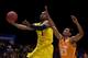INDIANAPOLIS, IN - MARCH 28: Glenn Robinson III #1 of the Michigan Wolverines shoots the ball against Derek Reese #23 of the Tennessee Volunteers during the regional semifinal of the 2014 NCAA Men's Basketball Tournament at Lucas Oil Stadium on March 28,