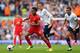 LIVERPOOL, ENGLAND - MARCH 30: Raheem Sterling of Liverpool competes with Gylfi Sigurdsson of Tottenham Hotspur during the Barclays Premier League match between Liverpool and Tottenham Hotspur at Anfield on March 30, 2014 in Liverpool, England. (Photo