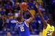 INDIANAPOLIS, IN - MARCH 30: Aaron Harrison #2 of the Kentucky Wildcats shoots the game winning shot late against Caris LeVert #23 of the Michigan Wolverines during the midwest regional final of the 2014 NCAA Men's Basketball Tournament at Lucas Oil Stad