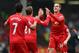 LIVERPOOL, ENGLAND - MARCH 30: Jordan Henderson of Liverpool celebrates with his team-mates after scoring the fourth goal during the Barclays Premier League match between Liverpool and Tottenham Hotspur at Anfield on March 30, 2014 in Liverpool, England.