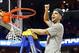 Mar 29, 2014; Memphis, TN, USA; Florida Gators guard Scottie Wilbekin (5) cuts the net after defeating the Dayton Flyers in the finals of the south regional of the 2014 NCAA Mens Basketball Championship tournament at FedEx Forum. Florida won 62-52. Mandat
