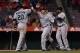ANAHEIM, CA - MARCH 31: (L-R) Logan Morrison #20, Justin Smoak #17 and Robinson Cano #22 of the Seattle Mariners celebrate Smoak's three-run home run against the Los Angeles Angels of Anaheim in the ninth inning during Opening Day at Angel Stadium of Ana