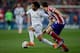 MADRID, SPAIN - MARCH 02: Marcelo (L) of Atletico de Madrid competes for the ball with Juan Francisco Torres alias Juanfran (R) of Atletico de Madrid during the La Liga match between Club Atletico de Madrid and Real Madrid CF at Vicente Calderon Stadium o