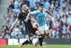 MANCHESTER, ENGLAND - MARCH 09: Sergio Aguero of Manchester City battles with Josh McEachran of Wigan Athletic during the FA Cup Quarter-Final match between Manchester City and Wigan Athletic at the Etihad Stadium on March 9, 2014 in Manchester, England