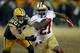 GREEN BAY, WI - JANUARY 05: Frank Gore #21 of the San Francisco 49ers runs the ball in the fourth quarter against A.J. Hawk #50 of the Green Bay Packers during their NFC Wild Card Playoff game at Lambeau Field on January 5, 2014 in Green Bay, Wisconsin.