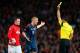 MANCHESTER, ENGLAND - APRIL 01: Wayne Rooney of Manchester United looks on as Bastian Schweinsteiger of Bayern Muenchen receives his first yellow card from Referee Carlos Velasco Carballo during the UEFA Champions League Quarter Final first leg match bet